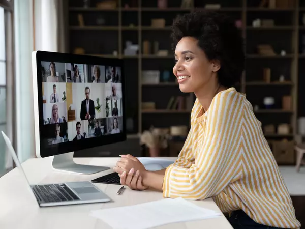 Happy african american employee talking on video conference call.