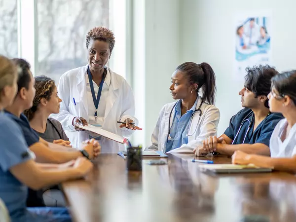 Physician offering bereavement training to small group.