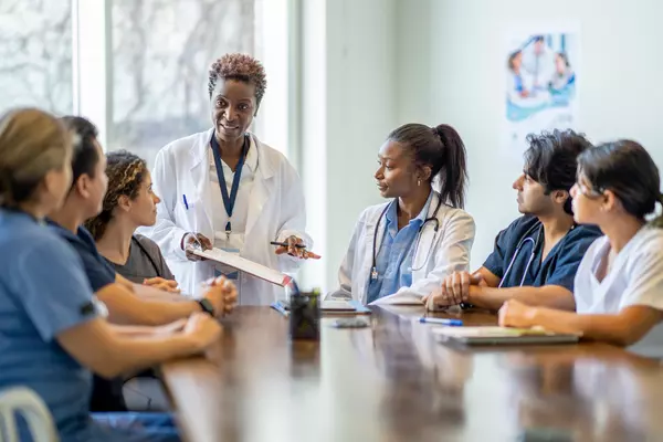 Physician offering bereavement training to small group.